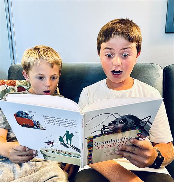 Two boys look surprised reading Grandmother Mosquito